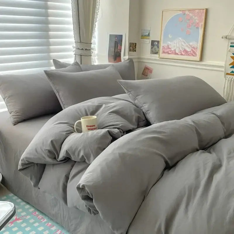 Decorbites duvet cover bedding set in white and dark gray on a gray bed with matching pillows on Tampa Home & Garden Store