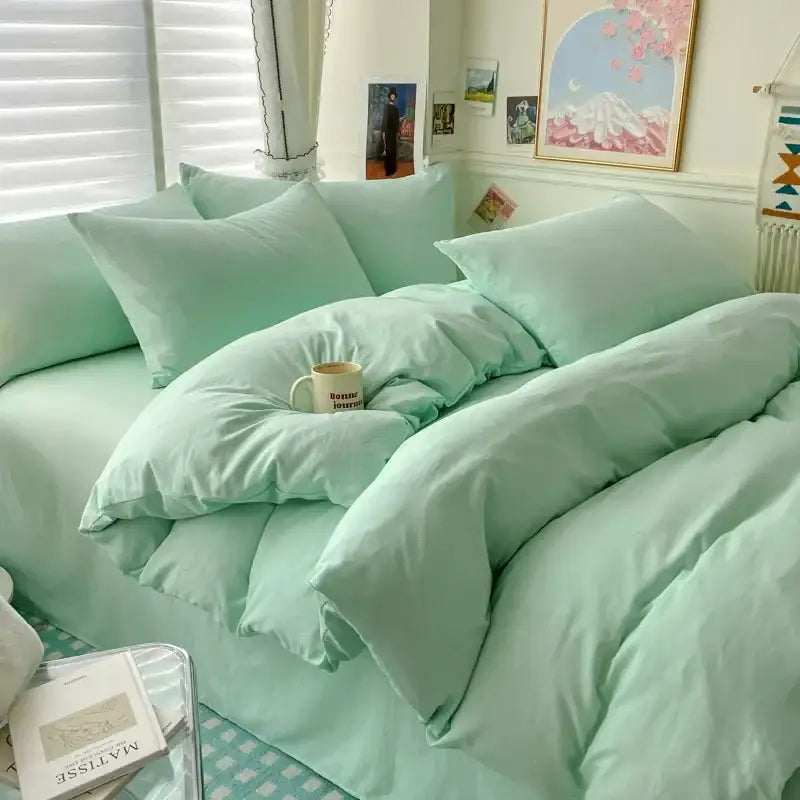 Mint green duvet cover bedding set with matching pillows on a cozy bed in a bright bedroom on Tampa Home & Garden Store