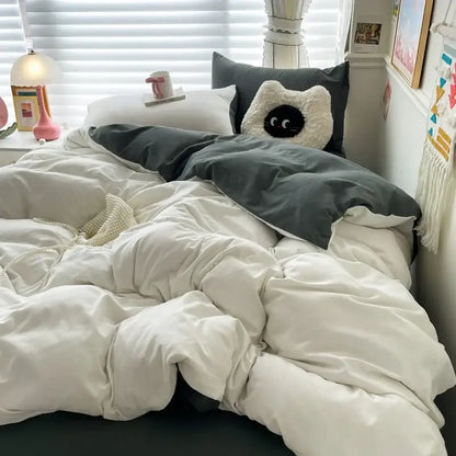 Duvet cover set by Decorbites in white and dark gray on a cozy bed on Tampa Home & Garden Store
