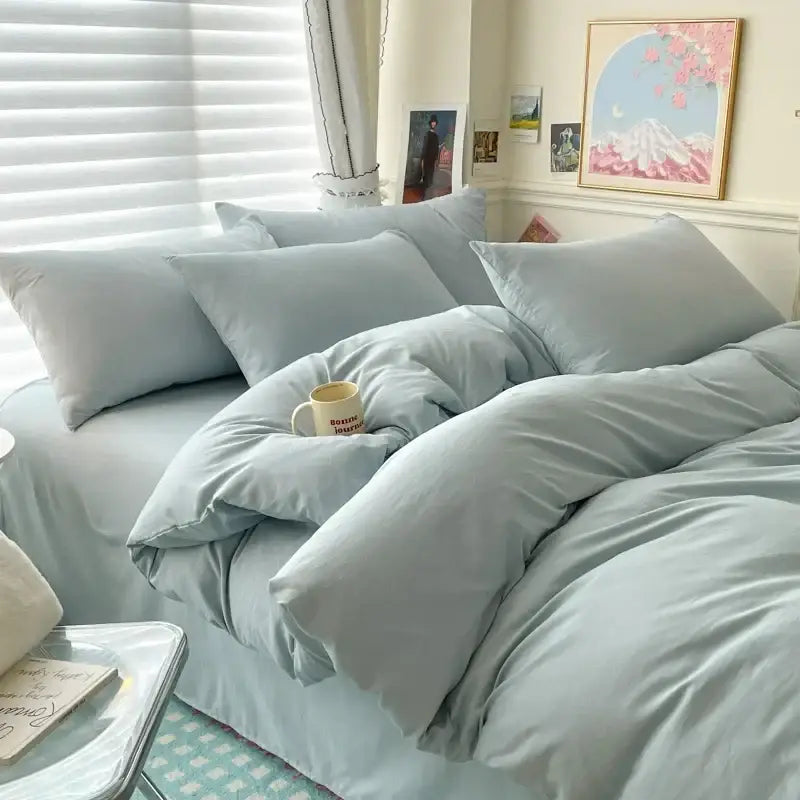 Decorbites duvet cover bedding set white and gray with several pillows in a bright bedroom on Tampa Home & Garden Store