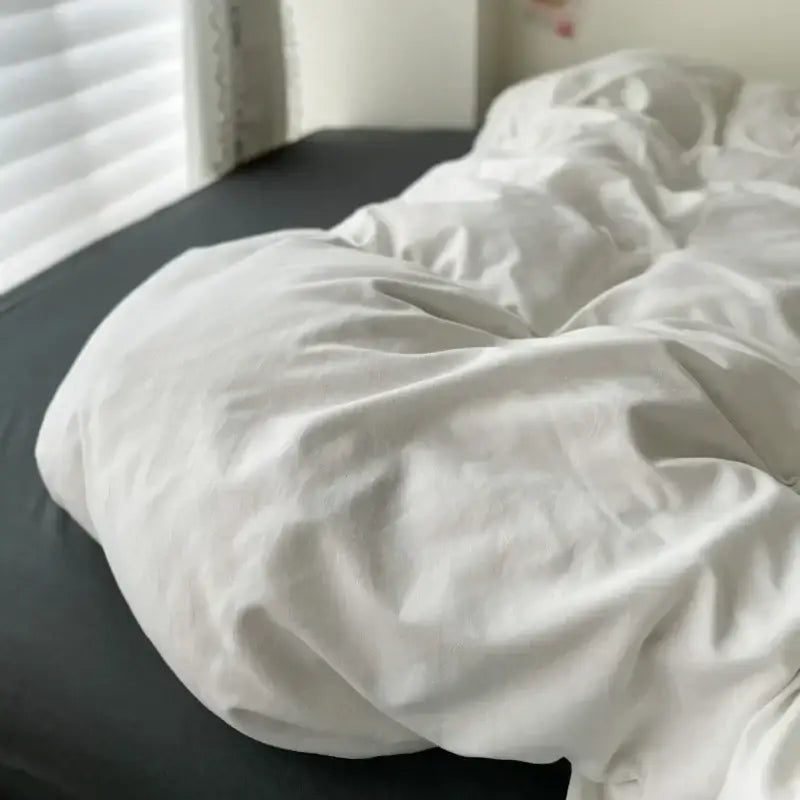 Decorbites duvet cover set in white and dark gray on bed on Tampa Home & Garden Store