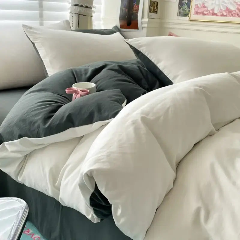 Decorbites duvet cover set in white and dark gray on bed with white pillows on Tampa Home & Garden Store