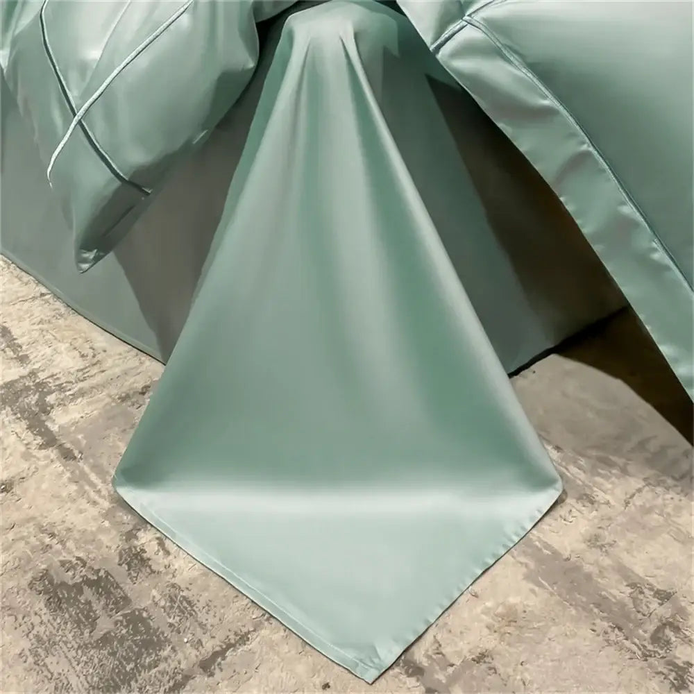 Decorbites Egyptian cotton duvet cover set in sage green with satin sheen draped on floor on Tampa Home & Garden Store