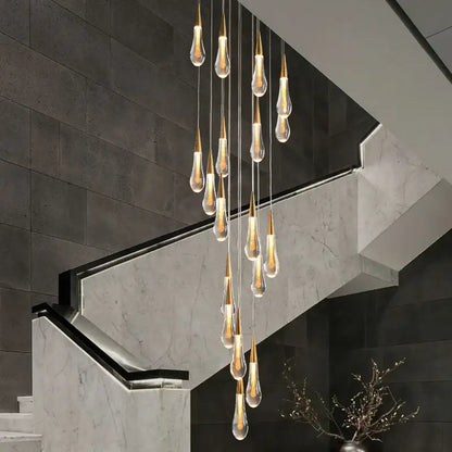 Gold Teardrop Chandelier with cascading glass teardrop pendants over a modern marble staircase on Tampa Home & Garden Store