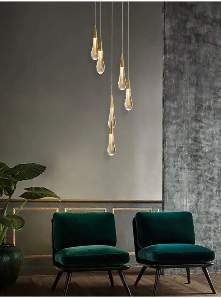 Gold Teardrop Chandelier by Decorbites; six glass pendants with gold tips above teal chairs on Tampa Home & Garden Store