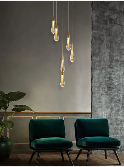 Gold Teardrop Chandelier by Decorbites; six glass pendants with gold tips above teal chairs on Tampa Home & Garden Store