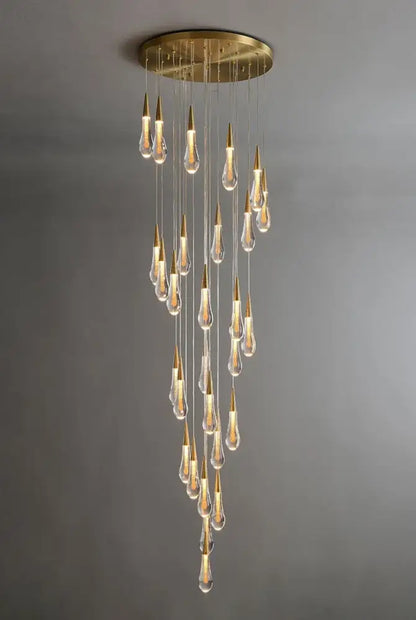 Gold teardrop chandelier with clear glass drops and gold tips, cascading from round ceiling plate on Tampa Home & Garden Store
