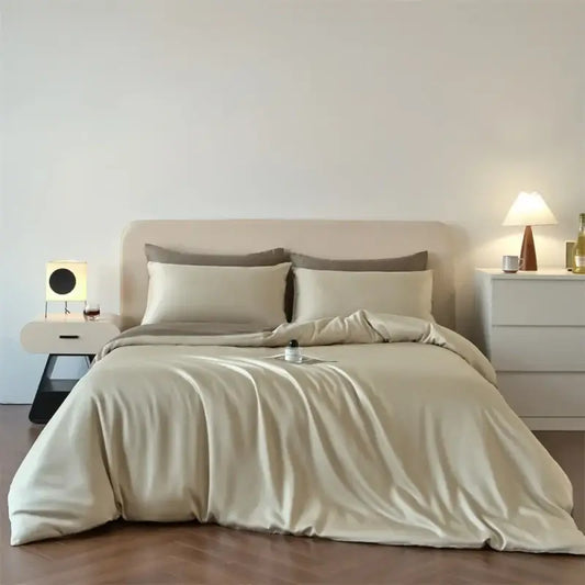 Decorbites beige lyocell silk duvet cover set with two pillow shams on a bed in a minimalist bedroom on Tampa Home & Garden Store