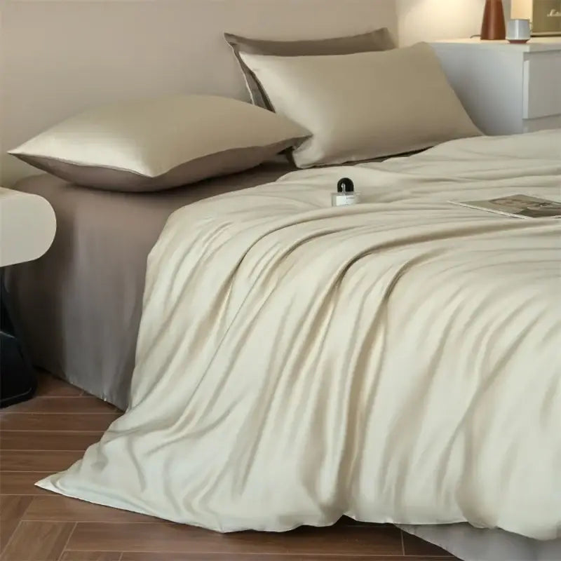 Luxurious beige lyocell silk duvet cover set with matching pillowcases on a neatly made bed on Tampa Home & Garden Store