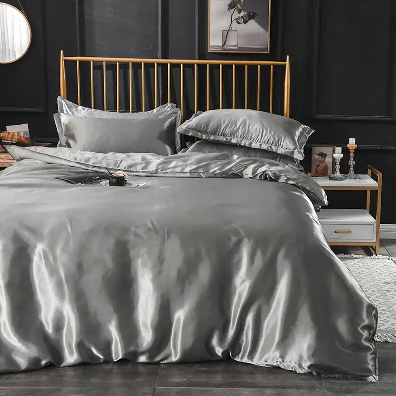 Decorbites grey satin duvet cover set with pillowcases on a gold bed frame in a modern bedroom on Tampa Home & Garden Store