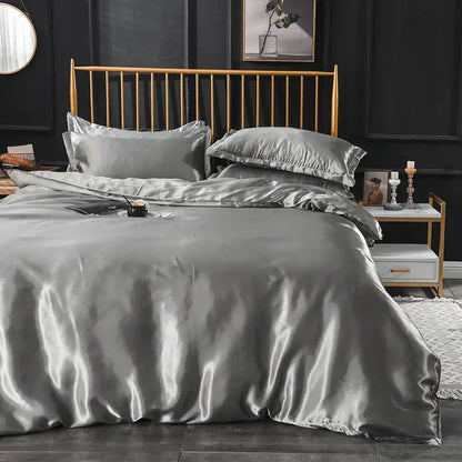 Decorbites grey satin duvet cover set with pillowcases on a gold bed frame in a modern bedroom on Tampa Home & Garden Store