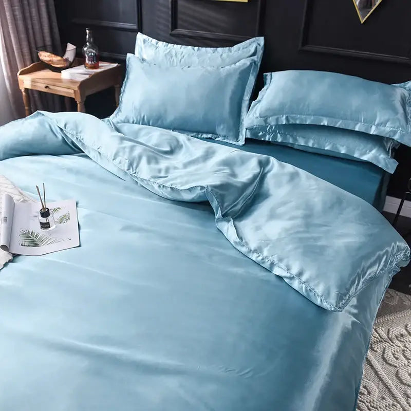Luxurious blush pink silk duvet cover set by Decorbites on a made bed with matching pillow shams on Tampa Home & Garden Store