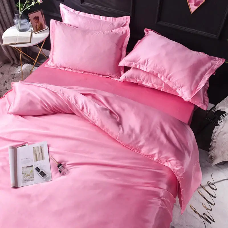Luxurious blush pink silk duvet cover set with 4 pink pillows by Decorbites on bed on Tampa Home & Garden Store