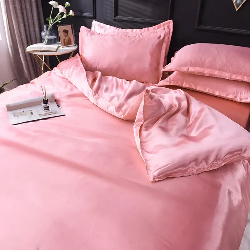 Decorbites blush pink silk duvet cover set with matching pillow shams on a neatly made bed on Tampa Home & Garden Store