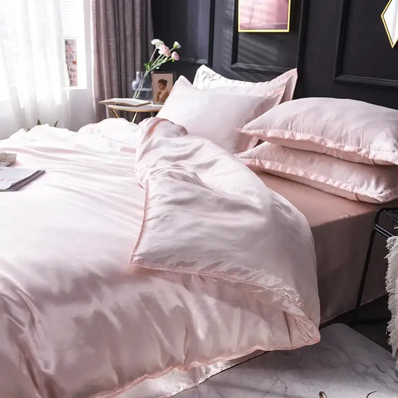 Luxurious blush pink silk duvet cover set with pillowcases from Decorbites on a bedroom bed on Tampa Home & Garden Store
