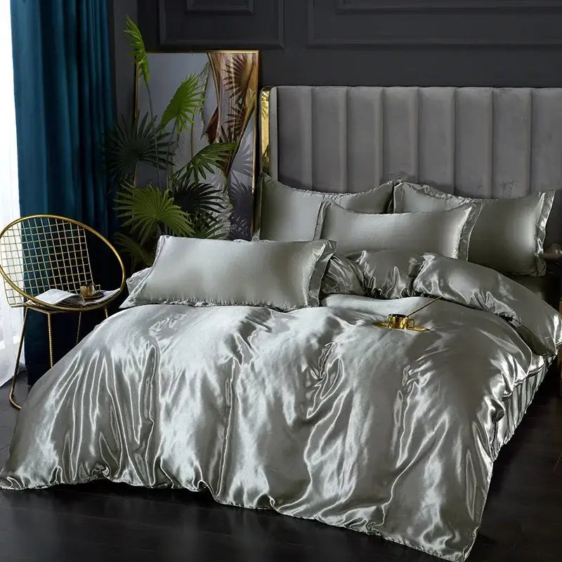 Gray satin duvet cover set with matching pillow shams in a luxurious dark bedroom on Tampa Home & Garden Store