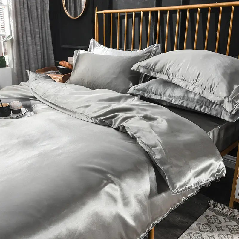 Silk gray duvet cover set with matching pillowcases on a gold bed frame on Tampa Home & Garden Store