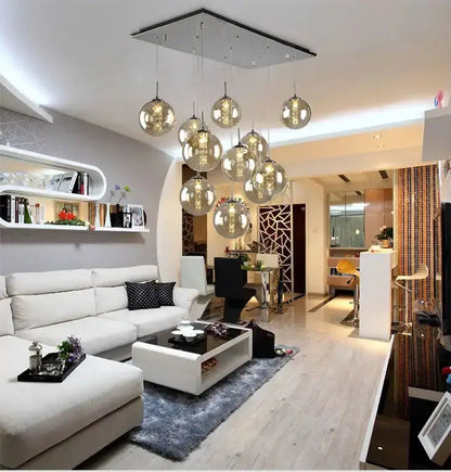 Chandelier modern loft dark amber glass spiral pendant with globe lights over a living area on Tampa Home & Garden Store