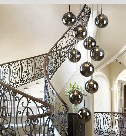Chandelier: modern loft dark amber glass spiral with pendant globes over wrought-iron stairs on Tampa Home & Garden Store