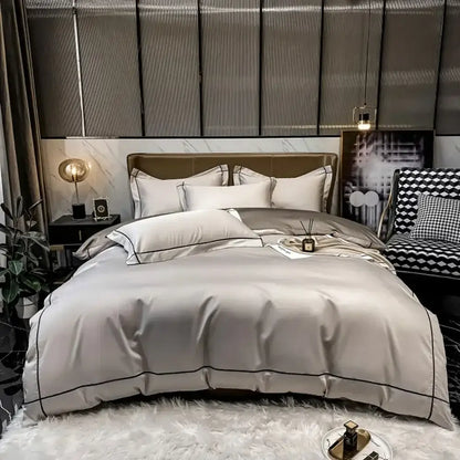 Decorbites Egyptian cotton duvet cover set in light grey with black piping on a plush bed on Tampa Home & Garden Store