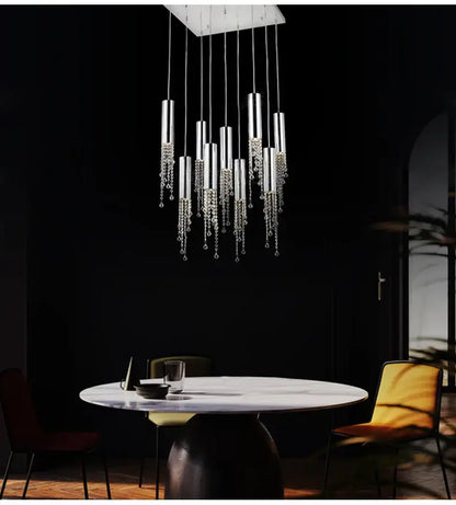 Chrome Cascading Chandelier with crystal droplets and tubular pendants over a white table on Tampa Home & Garden Store