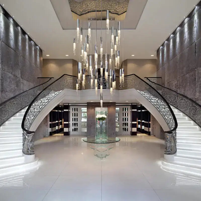 Chrome Cascading Chandelier with crystal prisms over a grand foyer staircase by Decorbites on Tampa Home & Garden Store