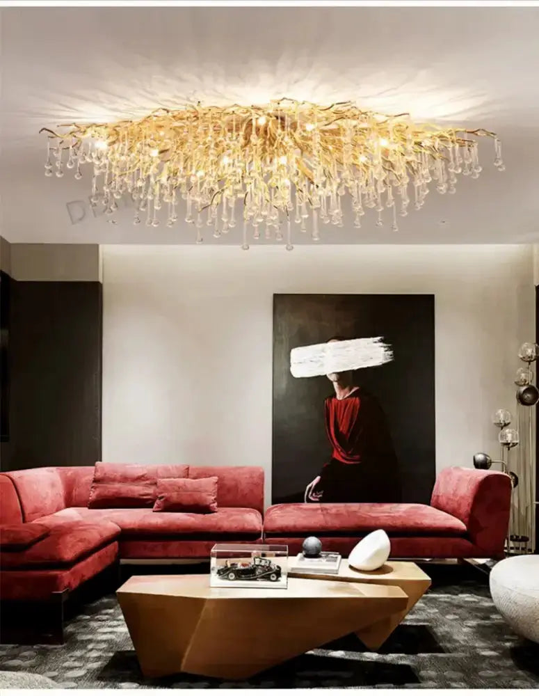Chandelier luxury gold branch crystal pendant light by Decorbites over red sectional living room on Tampa Home & Garden Store