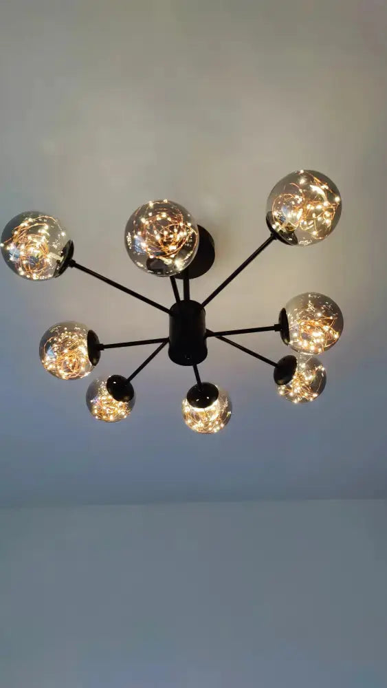 Modern black glass ball chandelier by Decorbites with radiating globes and warm string lights on Tampa Home & Garden Store