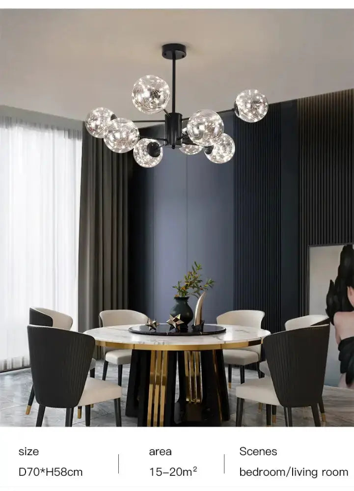 Modern black glass ball chandelier with clear globes over a round marble dining table on Tampa Home & Garden Store