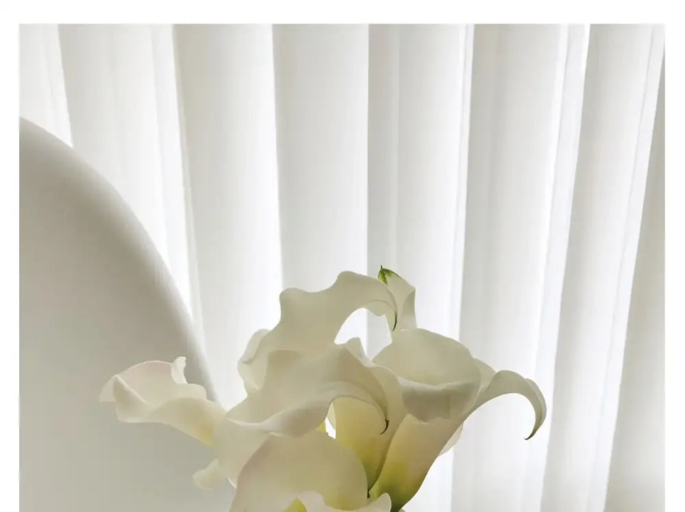 White calla lilies bouquet against soft sheer white curtains on Tampa Home & Garden Store