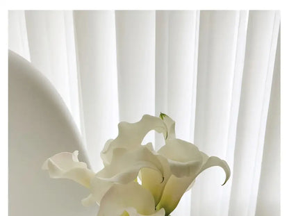 White calla lilies bouquet against soft sheer white curtains on Tampa Home & Garden Store
