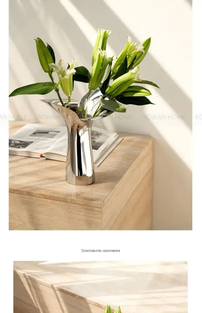 Silver stainless steel vase by Decorbites with lilies on a wooden surface on Tampa Home & Garden Store