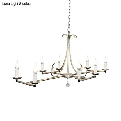 Antique brass candle chandelier with curved arms and candle-style lights on chain on Tampa Home & Garden Store