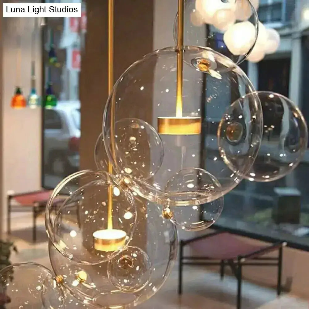 Modern brass bubble cluster pendant light with clear glass spheres by Decorbites on Tampa Home & Garden Store