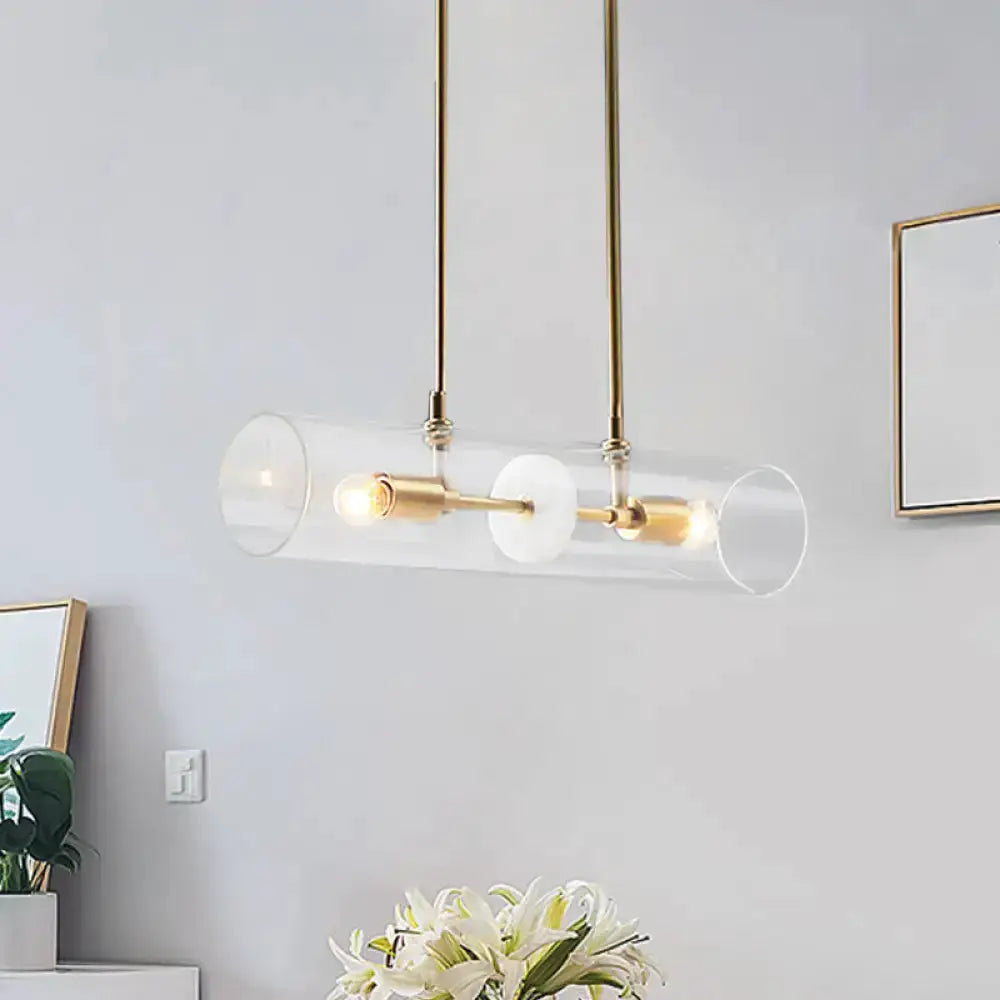 Modern brass island pendant light with clear glass cylinder and dual bulbs by Decorbites on Tampa Home & Garden Store