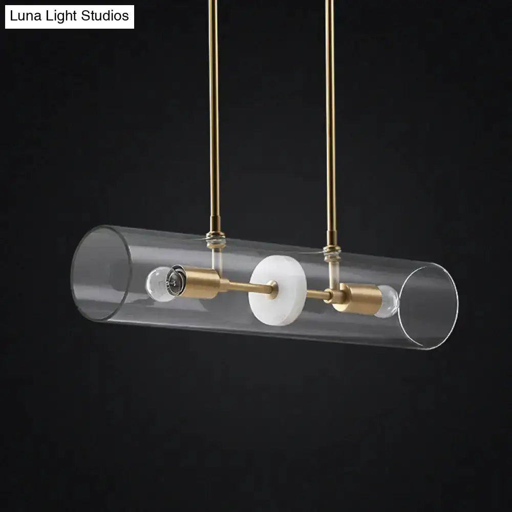 Modern brass finish island pendant with clear glass cylinder shade and brass hardware on Tampa Home & Garden Store