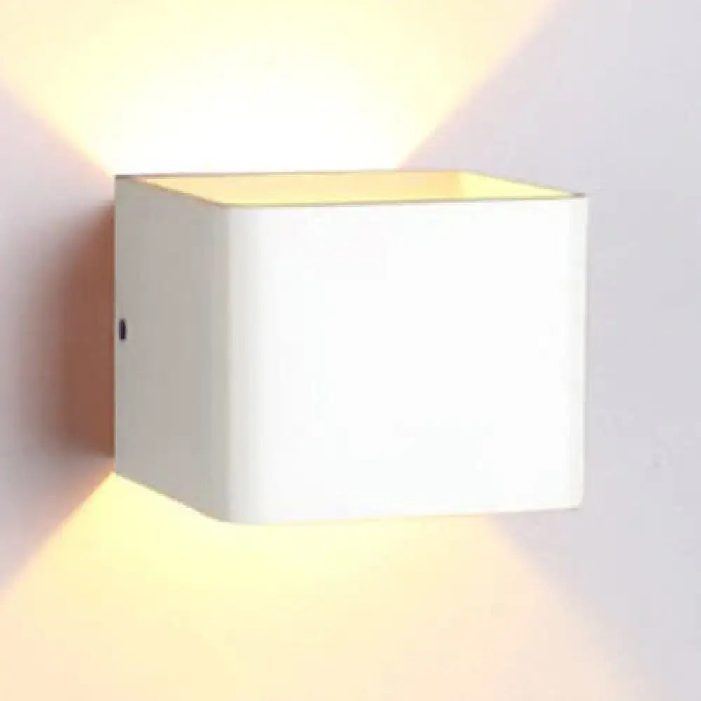 Black Cube Wall Sconce by Decorbites casts warm upward and downward light on wall on Tampa Home & Garden Store
