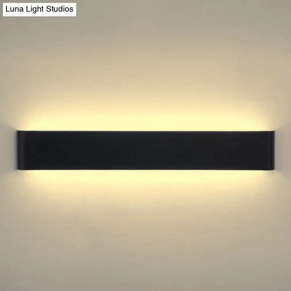 Black wall lamp sconce by Decorbites, slim rectangular metal bar with warm uplight and downlight on Tampa Home & Garden Store