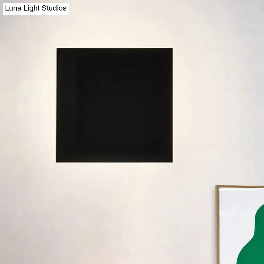 Black Square Soft-Glow Wall Sconce on a light beige wall on Tampa Home & Garden Store