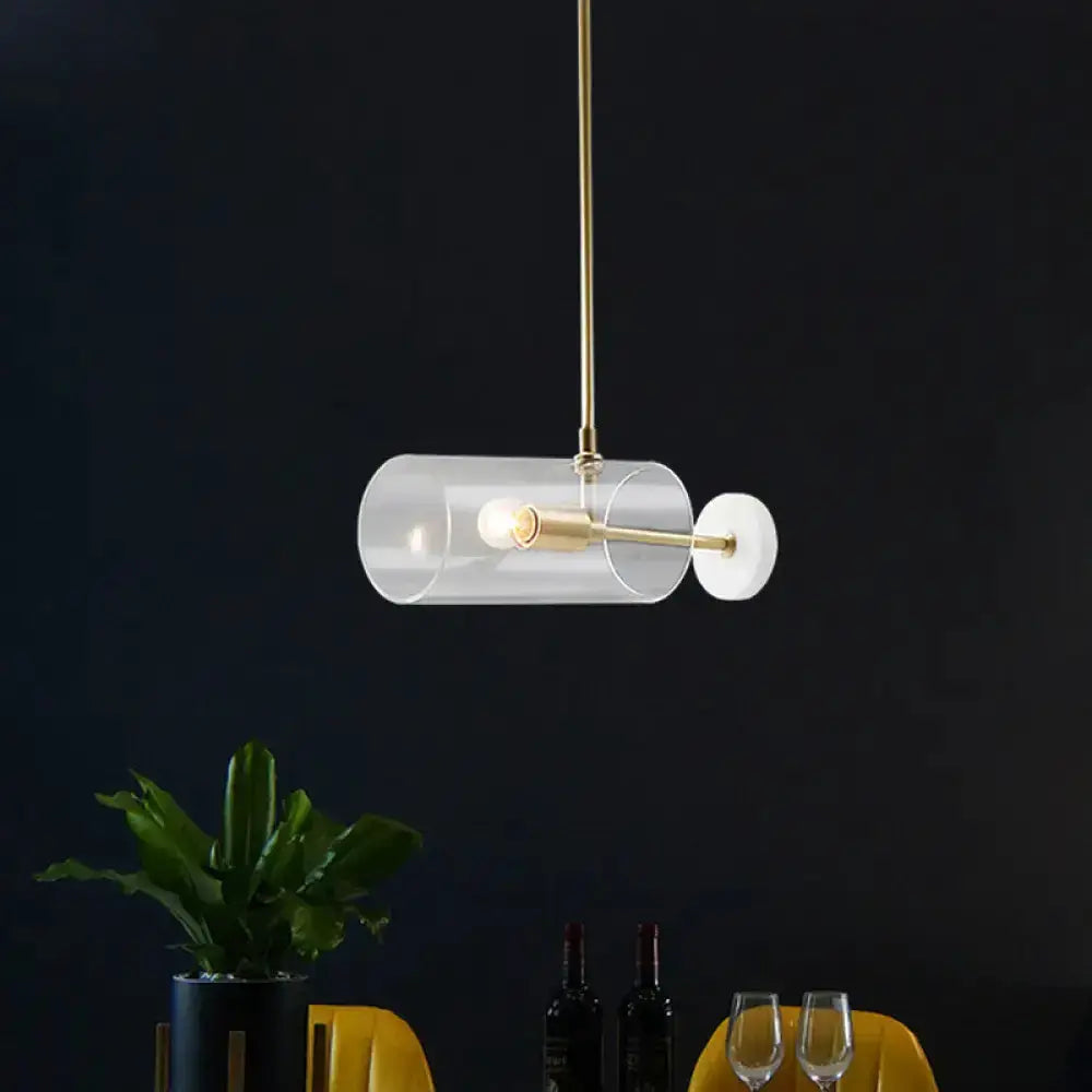 Modern brass pendant light with clear glass shade for dining table on Tampa Home & Garden Store