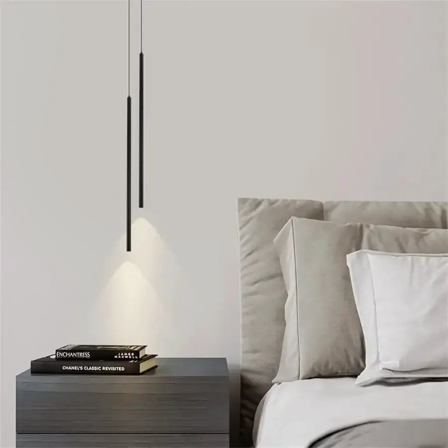 Pair of black 2cm LED pendant lights with slim cylinders over a grey nightstand beside bed on Tampa Home & Garden Store