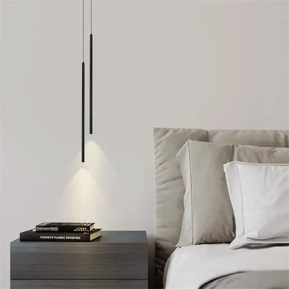 Pair of black 2cm LED pendant lights with slim cylinders over a grey nightstand beside bed on Tampa Home & Garden Store