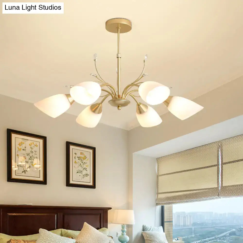 Gold glass chandelier by Decorbites with six frosted glass shades in a brass finish on Tampa Home & Garden Store