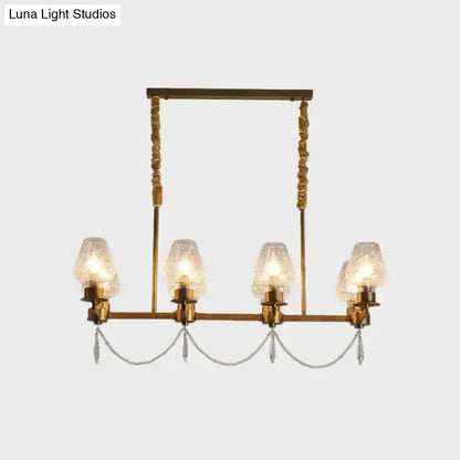 Modern brass crystal pendant island light with four candle-style glass shades and hanging crystals on Tampa Home & Garden Store