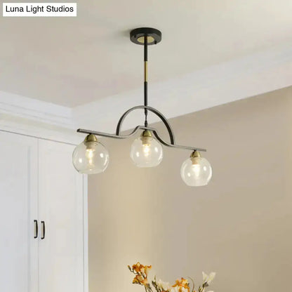 Decorbites black and brass arched pendant light with three clear white glass globes on Tampa Home & Garden Store