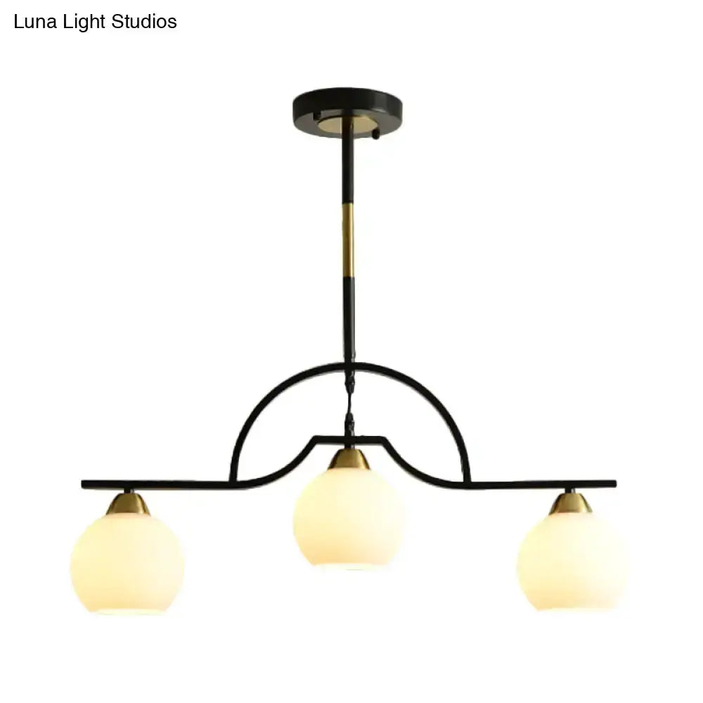 Modern black and brass arched pendant light with three clear white glass shades by Decorbites on Tampa Home & Garden Store