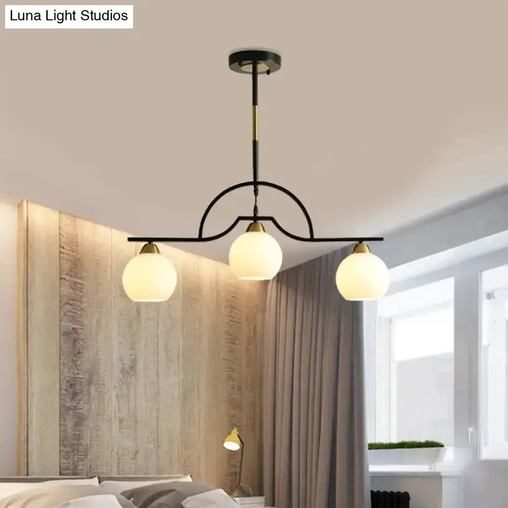 Modern black & brass arched pendant light by Decorbites with three clear glass globes on Tampa Home & Garden Store