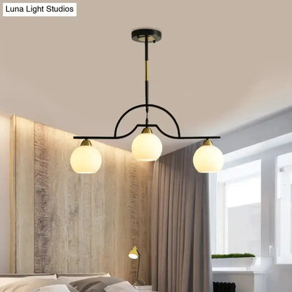 Modern black & brass arched pendant light by Decorbites with three clear glass globes on Tampa Home & Garden Store