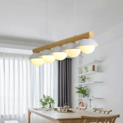 Decorbites five-light modern wood LED island pendant with white glass globes over dining table on Tampa Home & Garden Store
