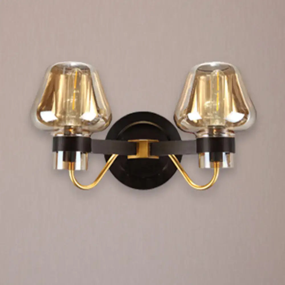 Amber glass mushroom double wall sconce with black backplate and brass accents on Tampa Home & Garden Store
